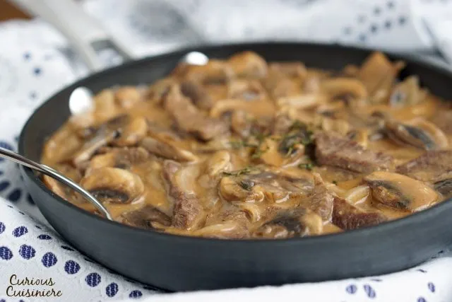 Beef Strogonoff is so much more than the 50s and 60s made it out to be. Our easy and authentic Russian Beef Stroganoff recipe combines tender beef and flavorful mushrooms in a creamy sauce for an elegant, yet quick dish. | www.CuriousCuisiniere.com 