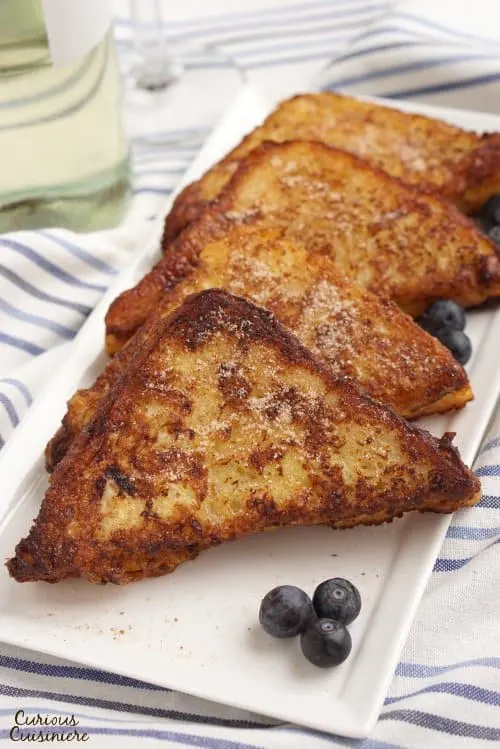 Leave it to the Spanish to think of using wine to soak their French Toast! Torrijas are a traditional Lent and Easter treat made from soaked bread that is deep fried and served with cinnamon sugar or honey. You’ll want to give this version of French Toast a try! | www.CuriousCuisiniere.com