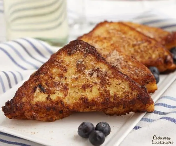 Leave it to the Spanish to think of using wine to soak their French Toast! Torrijas are a traditional Lent and Easter treat made from soaked bread that is deep fried and served with cinnamon sugar or honey. You’ll want to give this version of French Toast a try! | www.CuriousCuisiniere.com