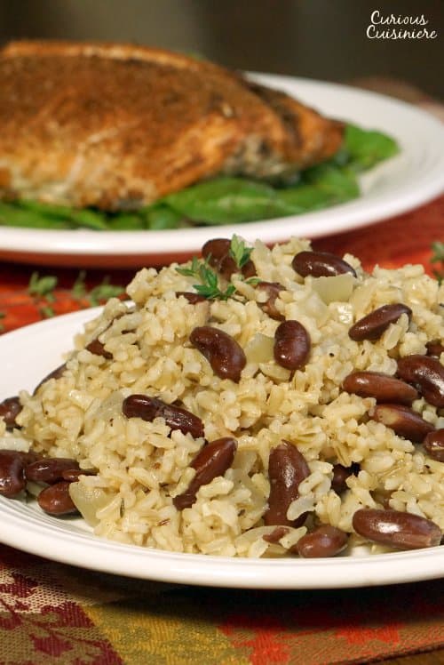 Jamaican Rice and Peas (or Caribbean Red Beans and Coconut Rice) is an easy and flavorful side dish that brings a fun tropical flair to your meal. | www.CuriousCuisiniere.com