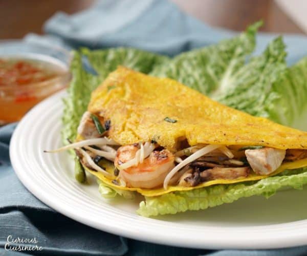Bánh xèo are savory Vietnamese pancakes that bring a light rice batter and unique fillings together for one tasty, crispy breakfast or snack! | www.CuriousCuisiniere.com