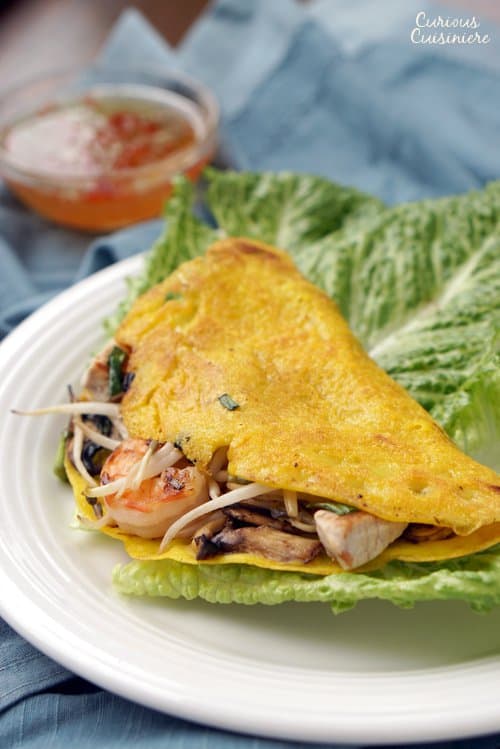 Bánh xèo, or Vietnamese Happy Pancakes, are crepe-like rice flour pancakes that bring a light batter and ample fillings together for one tasty, crispy breakfast or snack! | www.CuriousCuisiniere.com 