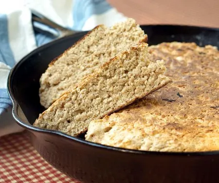 Scottish Bannock bread is cooked in a skillet from a simple dough, making it the perfect recipe for cooking up fresh bread around your summer campfire! | www.CuriousCuisiniere.com