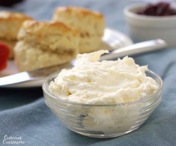 Clotted Cream is the essential companion to British scones, and it's so easy to make at home! | www.CuriousCuisiniere.com