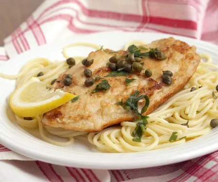 Lemon Chicken Piccata is an easy and flavorful dish that is the perfect recipe for a quick weeknight dinner. | www.CuriousCuisiniere.com