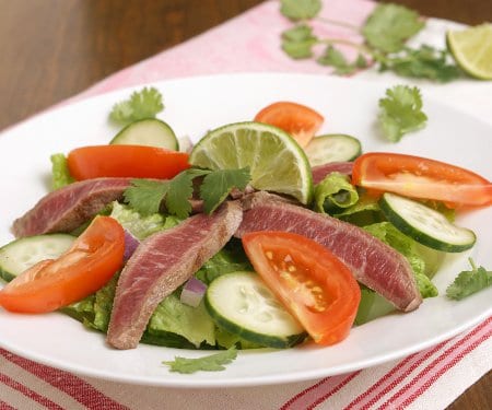 This grilled Thai Beef Salad, Yam Neua, is a simple salad with a bright and tangy Thai dressing, making for an easy and lighter way to enjoy your leftover summer grilled steak. | www.CuriousCuisiniere.com