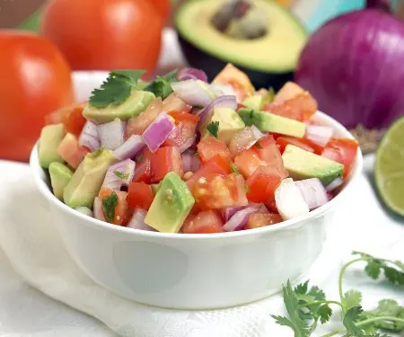 Kachumbari is a light and fresh tomato and onion salad that makes for a perfect summer side dish to pair with your grilled meats! | www.CuriousCuisiniere.com