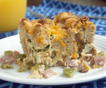 Leftover holiday ham becomes a delicious breakfast or brunch dish in this hearty Ham Strata. | www.curiouscuisiniere.com