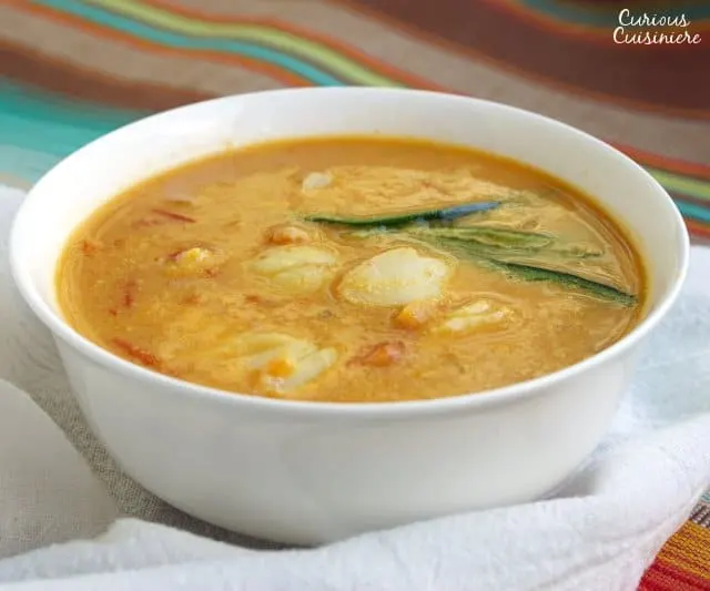 This Goan Fish Curry is a warm and tangy fish curry that is cooled with coconut milk. It's a perfect Indian seafood curry recipe to warm up with! | www.CuriousCuisiniere.com 
