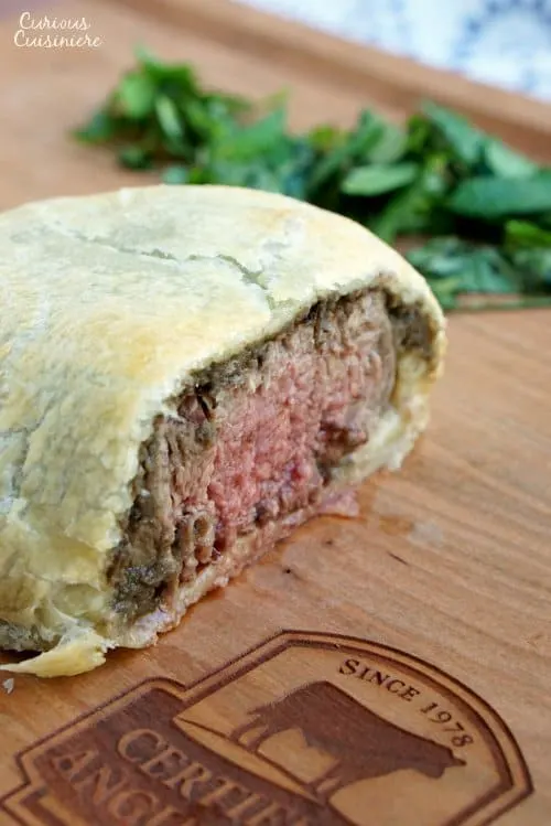 Individual Beef Wellington are an easy way to bring an over the top, classy feel to any special dinner. Our recipe pairs perfectly with a glass of smooth Merlot wine. | www.CuriousCuisiniere.com