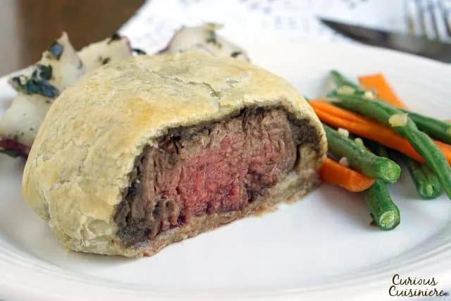 Individual Beef Wellington are an easy way to bring an over the top, classy feel to any special dinner. Our recipe pairs perfectly with a glass of smooth Merlot wine. | www.CuriousCuisiniere.com