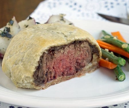 Individual Beef Wellington are an easy way to bring an over the top, classy feel to any special dinner. Our recipe pairs perfectly with a glass of smooth Merlot wine. | www.CuriousCuisiniere.com