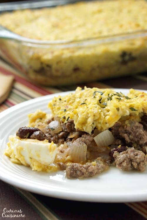 Pastel de Choclo is a comforting recipe for a Chilean beef and corn casserole. With a wonderful combination of flavors and classic South American ingredients, it is the perfect dinner dish for fall and beyond.   | www.CuriousCuisiniere.com