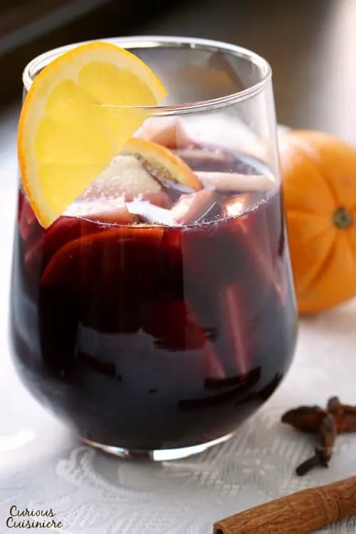 Warm spices and winter fruit make this Spiced Winter Sangria recipe a fun twist on your classic Spanish red sangria. | www.CuriousCuisiniere.com 