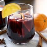 Warm spices and winter fruit make this Spiced Winter Sangria recipe a fun twist on your classic Spanish red sangria. | www.CuriousCuisiniere.com