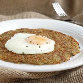 Swiss Potato Rosti is your classic recipe for a satisfying potato pancake. Traditionally eaten for breakfast, we serve our Rosti with eggs. It's the perfect way to start the day! | www.CuriousCuisiniere.com