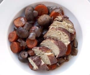 Our Slow cooker Coq Au Vin recipe makes this classic French dish of wine braised chicken perfect for an easy weeknight dinner.  | www.CuriousCuisiniere.com