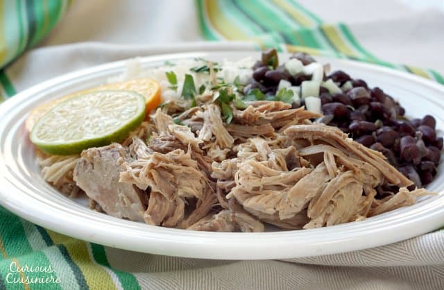 Tender and juicy Cuban Mojo Pork brings robust flavor of garlic and bright citrus notes to this easy, slow cooker recipe. | www.CuriousCuisiniere.com