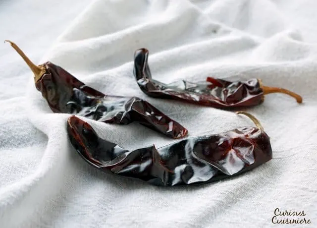 Guajillo chilie peppers are long, skinny, bright red chile peppers with a smooth skin. | www.CuriousCuisiniere.com