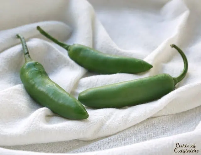 Serrano chilies look like thin jalapenos, but they are hotter, with thick, juicy walls. | www.CuriousCuisiniere.com