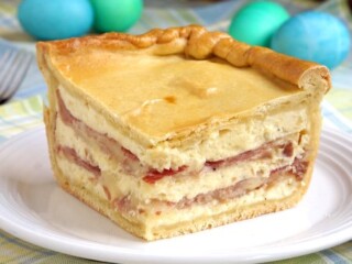 Pizza Gain (also known as Pizzagaina, Pizza Rustica, or Pizza Chiena) is an Italian Easter Pizza that is unlike any pizza you have ever tasted. Forget the tomato sauce, this filled pizza is more like a cheese and salami pie with a pizza crust. With beautiful layers, this impressive pie is the perfect dish for Easter brunch! | www.CuriousCuisiniere.com