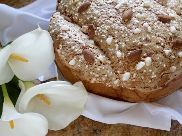 Colomba di Pasqua (literally "Easter dove") is a panettone-like bread that is shaped in the form of a dove. Almond studded bread with Easter lilies.