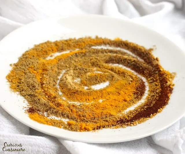 Warm ground spices swirled on a white plate.