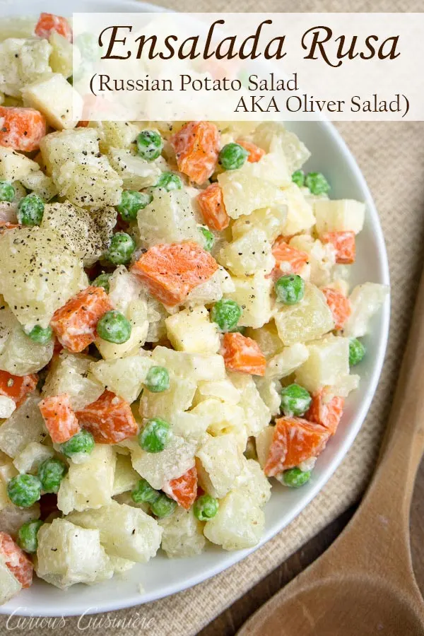 Ensalada Rusa is the Spanish name for a side dish that is popular in many countries but is best known as Oliver Salad, or Russian Potato Salad. This well known potato salad is full of vegetables, like peas, carrots, onions, and more. #potatosalad #picnicsidedish #sidedish | www.CuriousCuisiniere.com 
