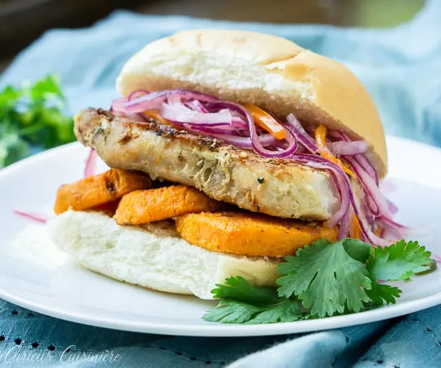 Pan Con Chicharron is a flavorful Peruvian sandwich made from the unique combination of slow braised pork and sweet potato topped with a crisp red onion relish. In Peru, it's traditionally eaten for breakfast, but we think it's the perfect meal for any time of day! | www.CuriousCuisiniere.com