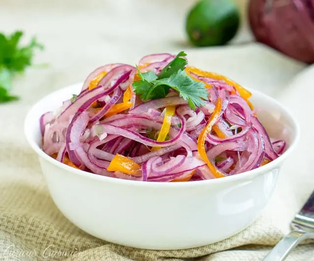 Red onions and chiles mingle with lime juice in this crisp and fresh Salsa Criolla recipe. It's the perfect side dish for grilled meats, topping for sandwiches, and so much more! | www.CuriousCuisiniere.com