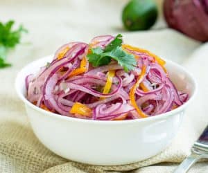 Red onions and chiles mingle with lime juice in this crisp and fresh Salsa Criolla recipe. It's the perfect side dish for grilled meats, topping for sandwiches, and so much more! | www.CuriousCuisiniere.com