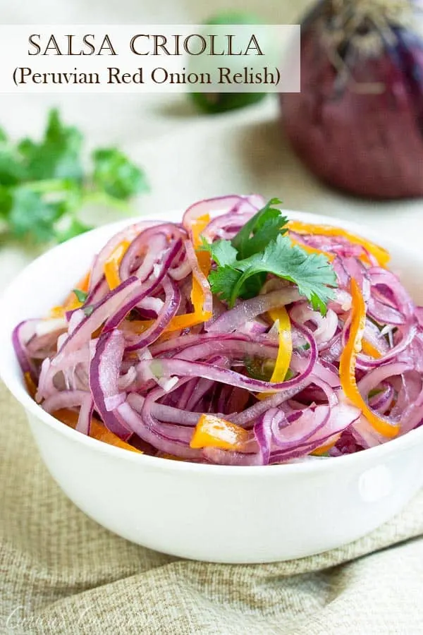 Red onions and chiles mingle with lime juice and cilantro in this crisp and fresh Salsa Criolla recipe. It's the perfect side dish for grilled meats, topping for sandwiches, and so much more! #summer #relish #pickledonions | www.CuriousCuisiniere.com
