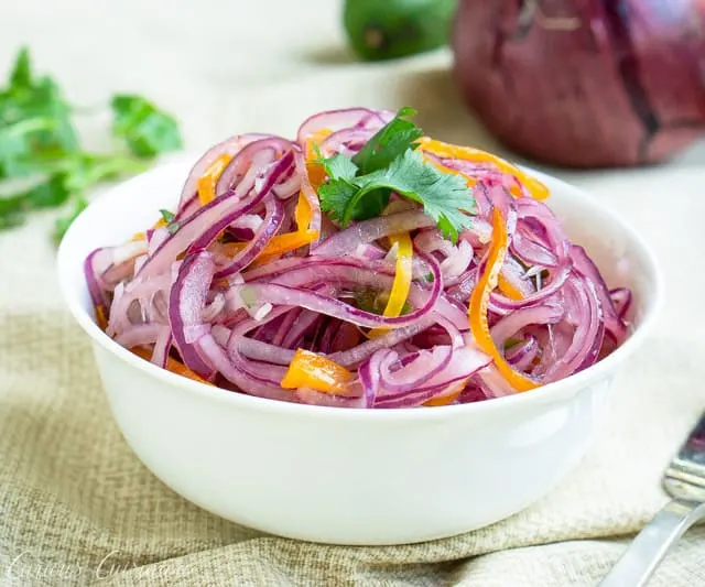 Red onions and chiles mingle with lime juice in this crisp and fresh Salsa Criolla recipe. It's the perfect side dish for grilled meats, topping for sandwiches, and so much more! | www.CuriousCuisiniere.com
