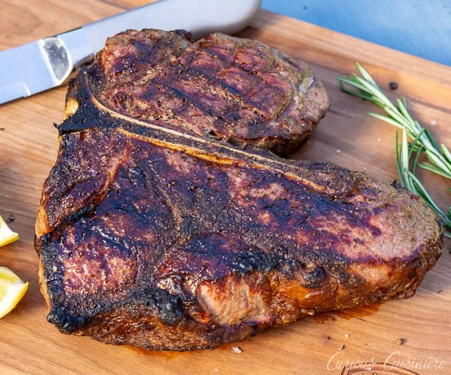Bistecca alla Fiorentina is an impressive dish of Porterhouse steak done Florentine style. This Florentine steak is a simple recipe, perfect for a summer dinner party. | www.CuriousCuisiniere.com 