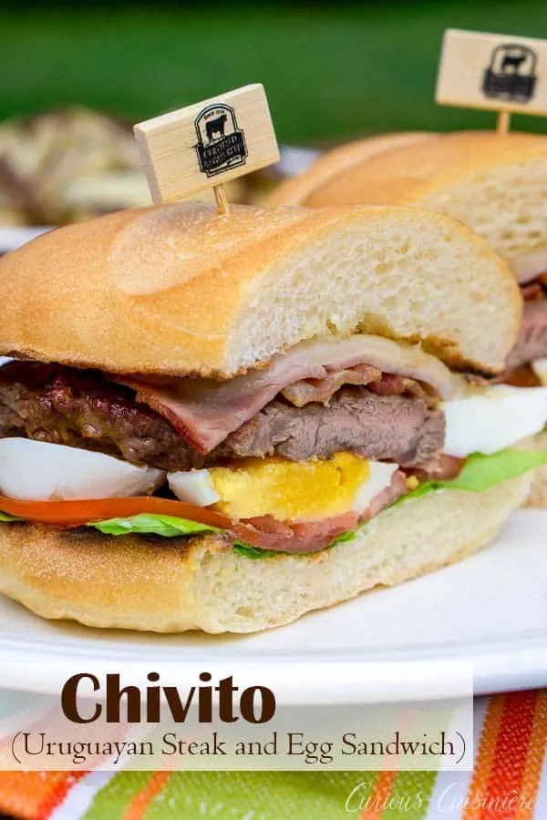 Chivito, the national dish of Uruguay, is a steak and egg sandwich unlike any other. This ultimate steak sandwich is perfect for a summer lunch or dinner! #sandwich #steaksandwich #bestangusbeef #steakandeggs | www.CuriousCuisiniere.com