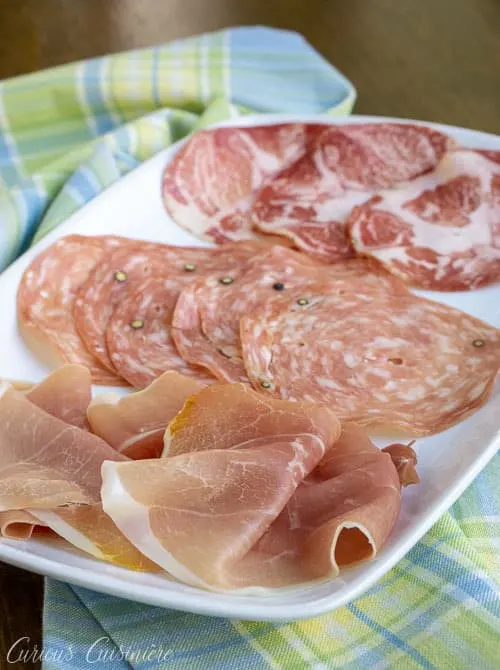 Have you heard of salumi? These tasty Italian cured meats, including Prosciutto, Pancetta, and Capocollo are perfect for sandwiches, appetizer spreads, and so much more!&nbsp;&nbsp;| www.CuriousCuisiniere.com 