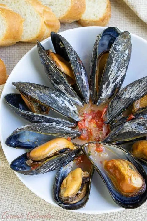 For an elegant summer appetizer, try these Galician Style Mussels in white wine and tomato sauce. These mussels&nbsp;are quick and easy to prepare. And, they are the perfect recipe to pair with a crisp Spanish white wine, like an Albari&ntilde;o.&nbsp;| www.CuriousCuisiniere.com 