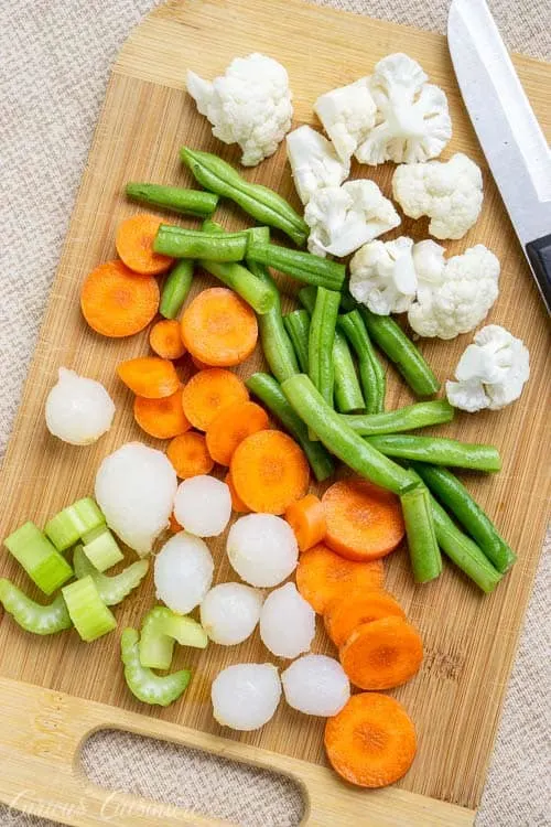 Traditional Italian Giardiniera is full of large chunks of pickled vegetables like cauliflower, green beans, carrots, onions, and celery.  | www.CuriousCuisiniere.com