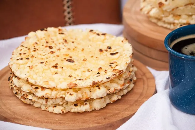 Mbejú is a buttery, gluten-free, cheese flatbread with crispy edges that is made with cassava flour and enjoyed all over Paraguay with a cup of coffee or cocido tea. | www.CuriousCuisiniere.com 