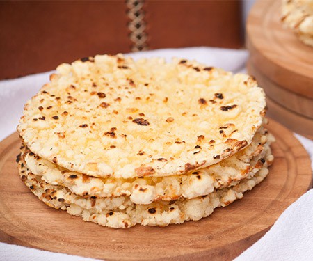 Mbejú is a buttery, gluten-free, cheese flatbread with crispy edges that is made with cassava flour and enjoyed all over Paraguay with a cup of coffee or cocido tea. | www.CuriousCuisiniere.com