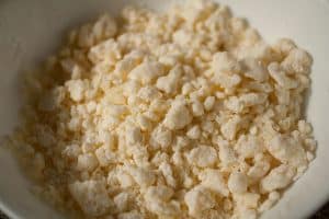 Cassava flour, cheese, butter, and a pinch of salt make up this crumbly mbeju dough mixture. | www.CuriousCuisiniere.com