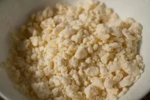 Cassava flour, cheese, butter, and a pinch of salt make up this crumbly mbeju dough mixture. | www.CuriousCuisiniere.com