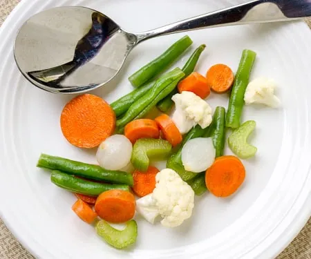 Traditional Italian Giardiniera is full of large chunks of pickled vegetables and is served as an antipasto or appetizer. This recipe for giardiniera for canning uses no oil, so it is the perfect way to preserve your summer produce.  | www.CuriousCuisiniere.com