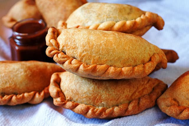 With a crispy-sweet crust and a juicy chicken filling, Empanadas de Pollo, Bolivian chicken empanadas, are a great recipe for your next get together. | www.CuriousCuisiniere.com