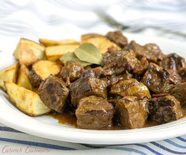 Carbonade Flamande is a Belgian beef stew with beer that is full of caramelized onions, bacon, and tender, slow cooked beef. Served with thick cut fries or boiled potatoes, this stew is the perfect recipe for winter comfort food. | www.CuriousCuisiniere.com