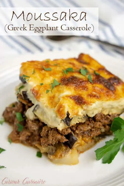 Greek Moussaka is an eggplant casserole filled with layers of eggplant and a warmly spiced meat sauce, all covered in a rich béchamel sauce. This is a recipe for some serious Greek comfort food! #eggplant #casserole #comfortfood | www.CuriousCuisiniere.com 