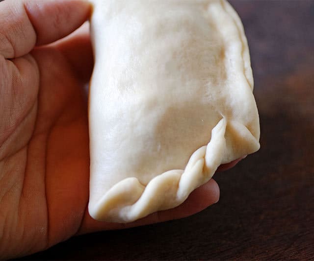 Sealing Bolivian chicken empanadas. | www.CuriousCuisiniere.com