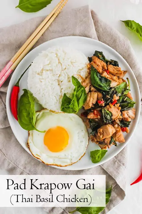 Pad Krapow Gai, Thai Basil Chicken, is savoury, aromatic, and garlicky. This recipe is so comforting and delicious served over rice with a fried egg. #basil #stirfry #thaifood | www.CuriousCuisiniere.com