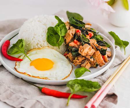 Close up of Pad Krapow Gai, Thai Basil Chicken, a savoury, aromatic, and garlicky Thai recipe. | www.CuriousCuisiniere.com