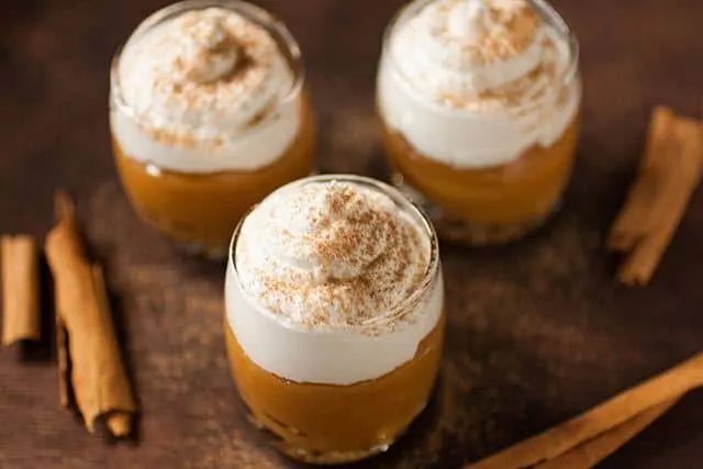 Suspiro de Limeña is a Peruvian dessert that originated in the city of Lima. Creamy, caramel like pudding (dulce de leche) is topped with a Port flavored meringue and sprinkled with a touch of cinnamon. | www.CuriousCuisiniere.com 